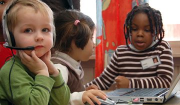 three kids around computer