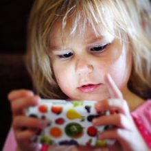 Child heavily focused on phone screen