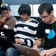 three students on laptops